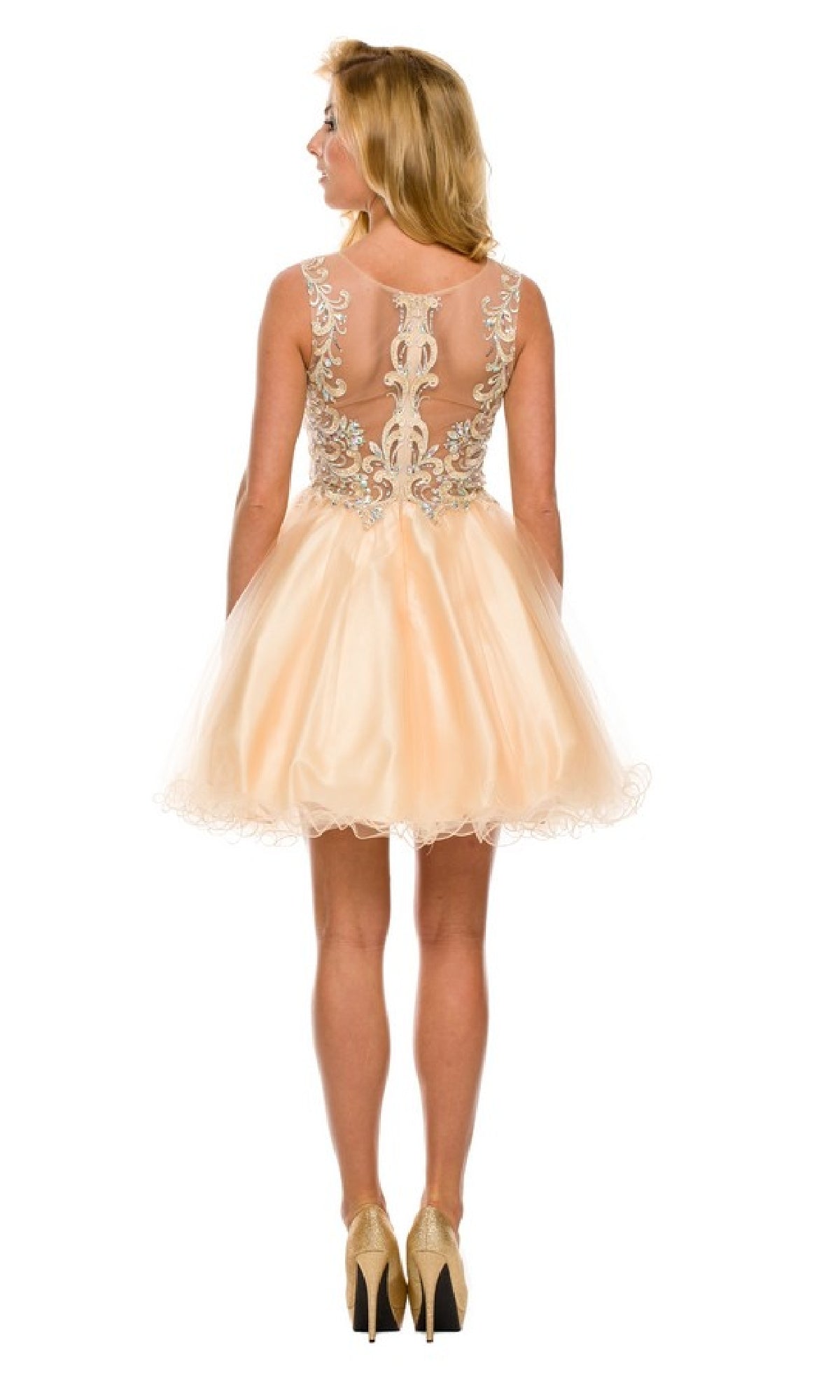 A woman facing away wears the Short Hoco Dress: Juliet 749, a peach homecoming dress with an embellished bodice, sheer embroidered back, and high heels.